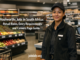 Professional retail worker in a clean Woolworths-style South African store with shelves, checkout area, and headline about Woolworths jobs in South Africa.