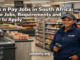 Retail worker in a clean South African supermarket near a checkout and stocked shelves for a Pick n Pay jobs article.